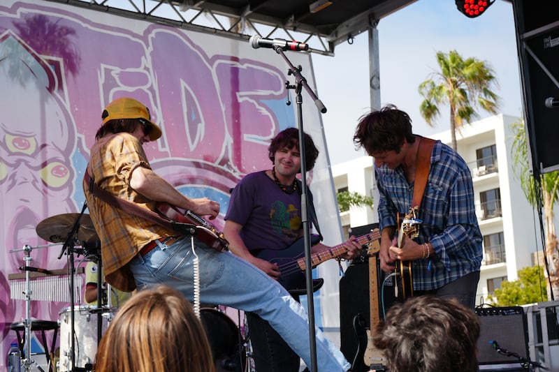 Three guys playing instruments.