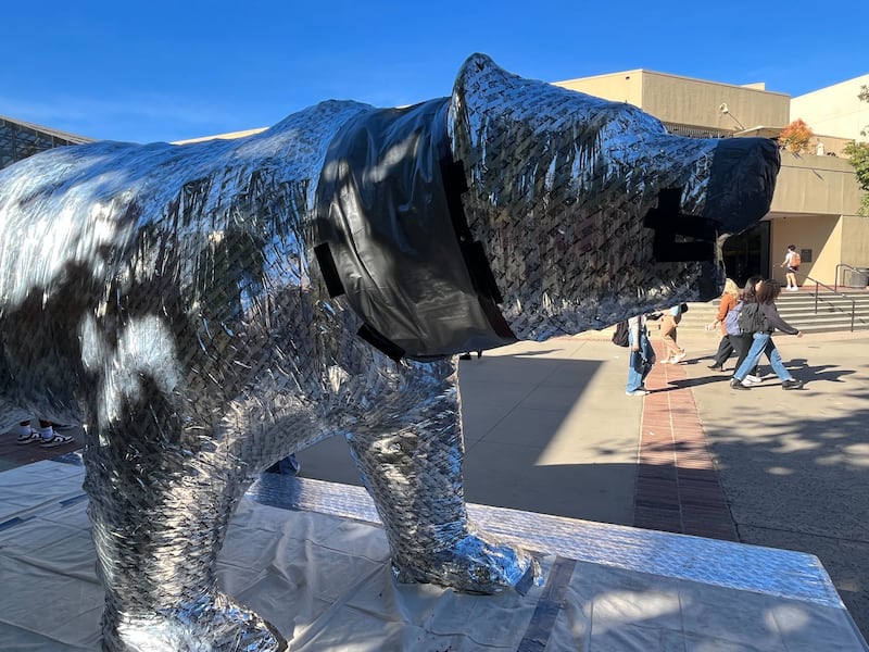 A statue of a bear wrapped in tape