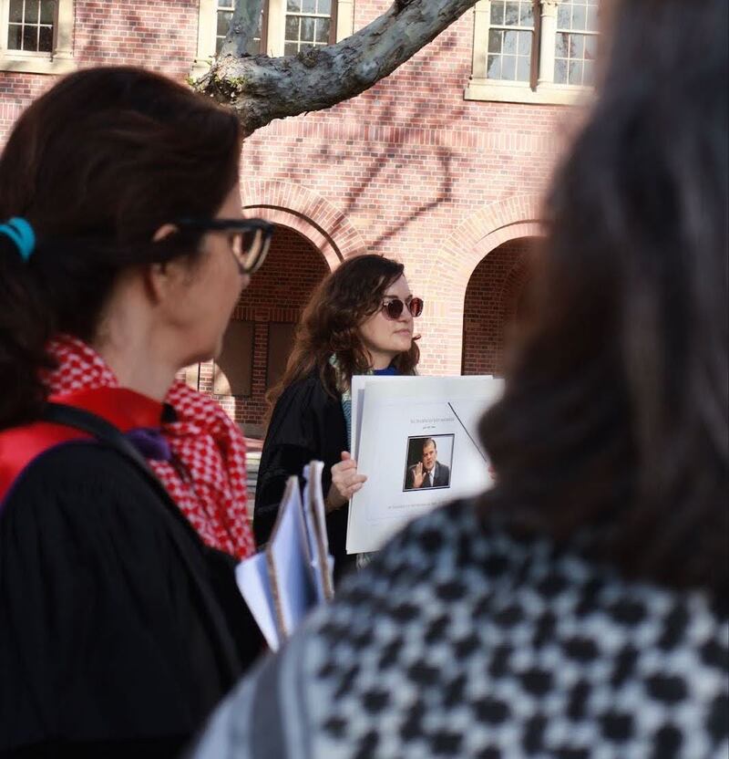 arah Kessler, an English professor, holds up a picture of Muhammad Eid Shabir, former President of the Islamic University of Gaza. Shabir was killed on Nov. 14 along with three members of his family.