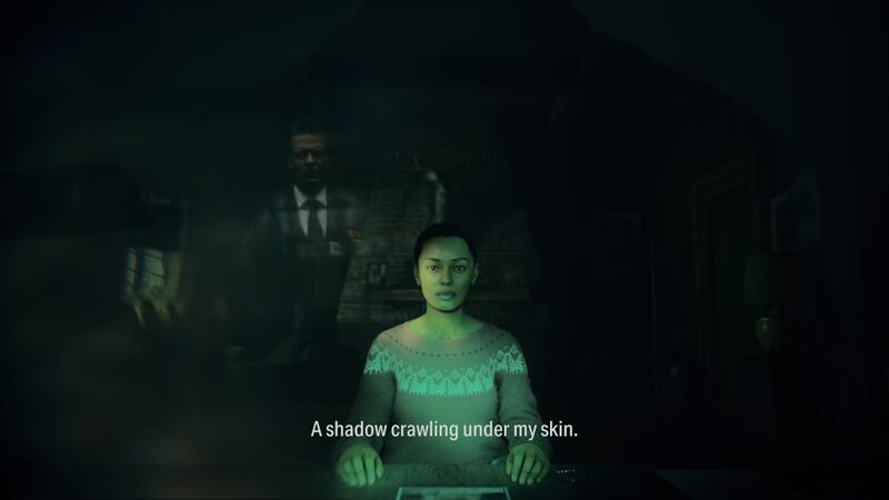 Video game screenshot of a woman sitting down with faded people in the background
