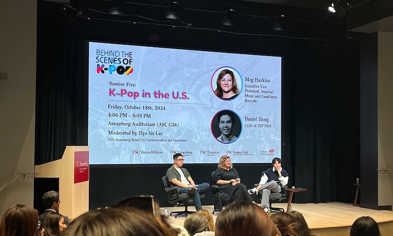 Photo of three people on a stage talking to audiences