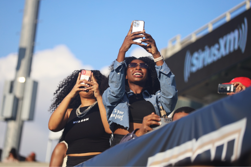 Fans watch the Alabama State University Marching Hornets with their phones recording during halftime of the Legacy Bowl.