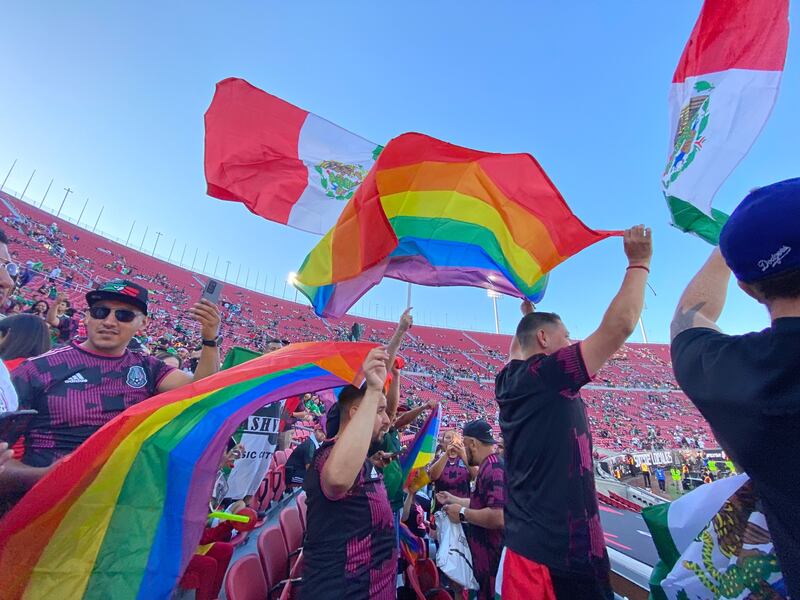 Members of Pancho Villa's Army wave Pride flags during a friendly between Mexico and Nigeria at the L.A. Memorial Coliseum on Saturday, July 3, 2021.