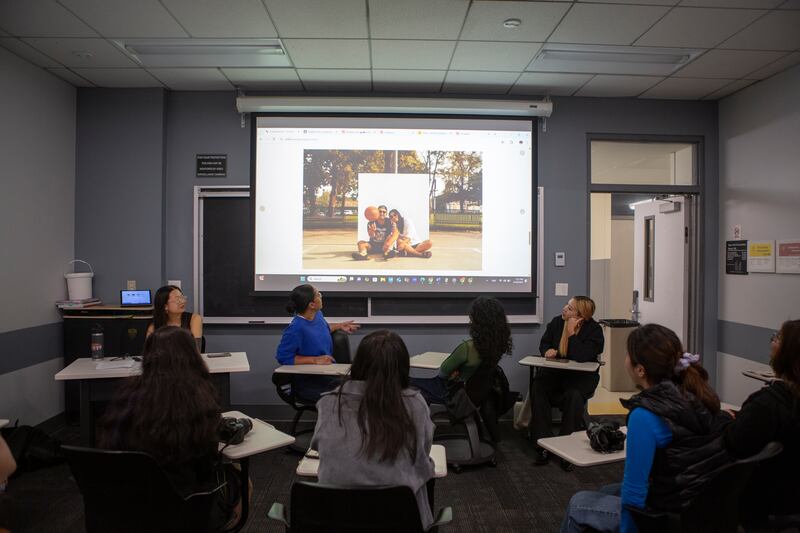 People looking at photographs on a projector.