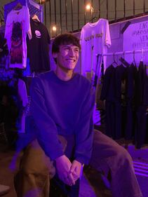 Photo of Thomas sitting in front of his booth.