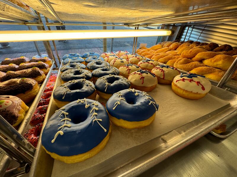 Photo of donuts with blue glaze and red glaze designed to look like a baseball with stitches