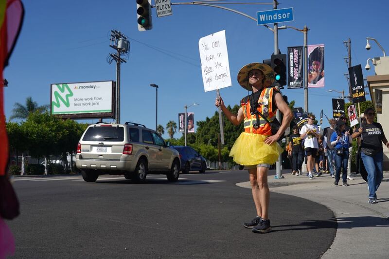 Photo of striking actor with a picket sign