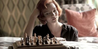 [Beth Harmon studies her chess board.]