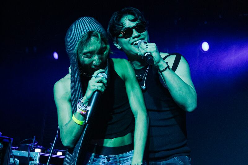 Photo of two people holding microphones
