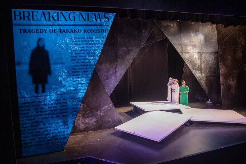 A photo of two women on stage in a play.