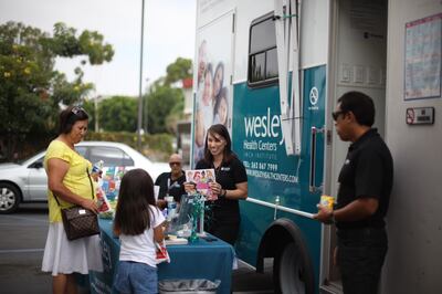 A photo of Daniela giving a book to a child