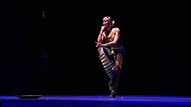 Kuchipudi, a dance-drama art, is characterized by fast rhythms and fluid movements. The performer takes a pose in the middle of a set.