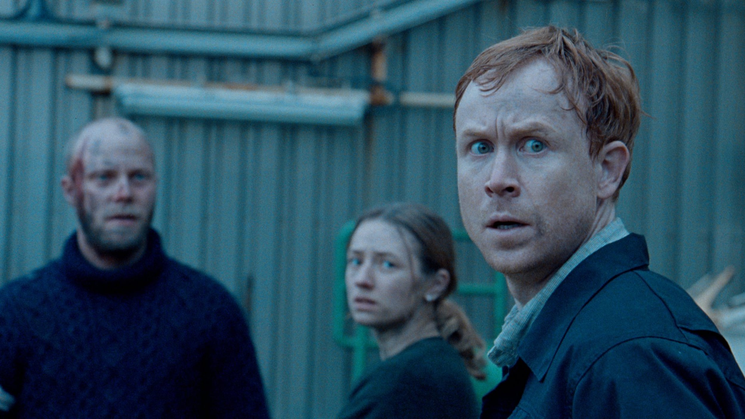 Photo of Henrik Bjelland, Kristine Kujath Thorp and Rolf Kristian Larson in “The Burning Sea” looking off-camera, concerned.